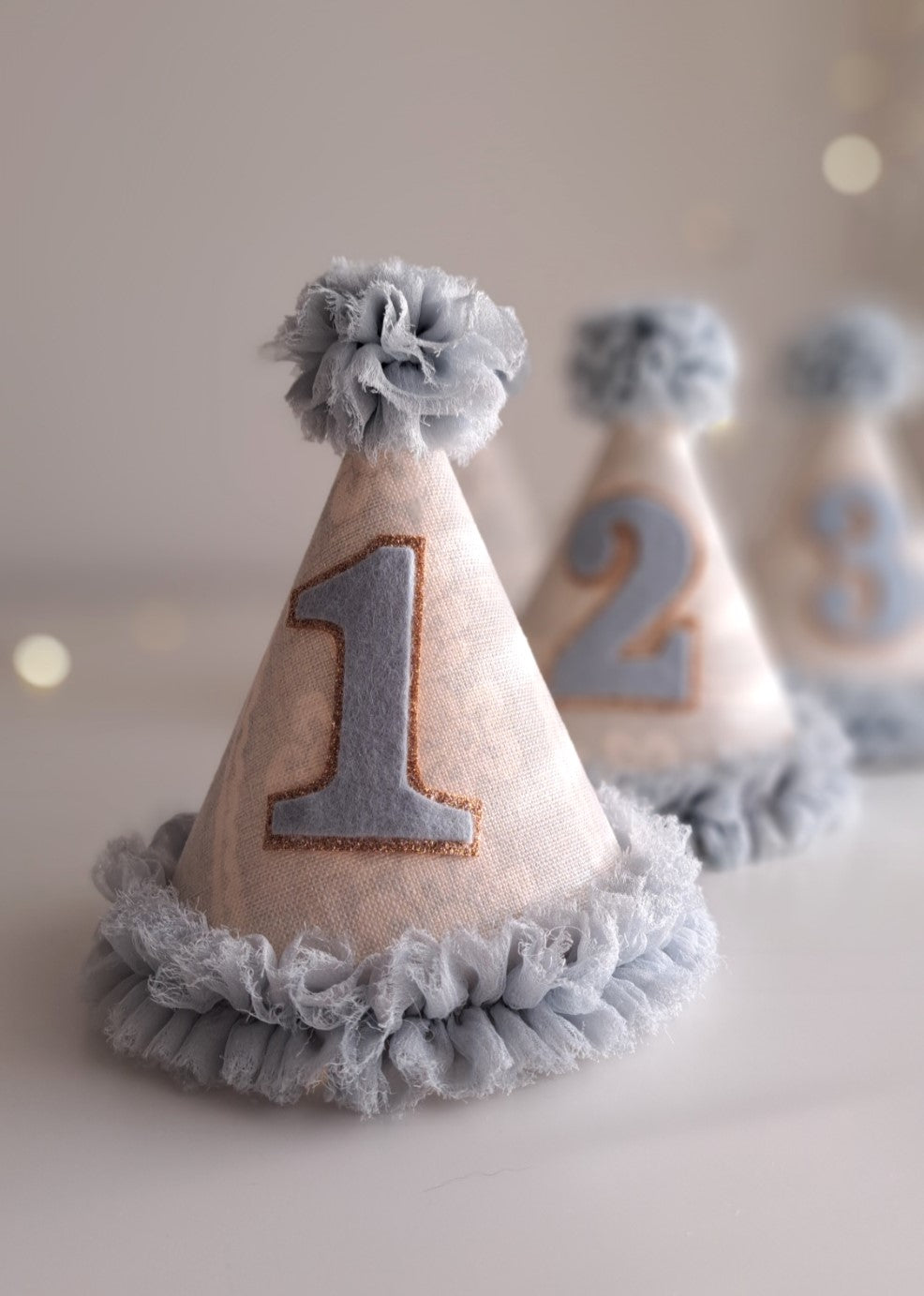 Decorative party hats with numbers on a light background.