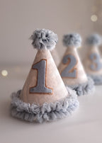 Decorative party hats with numbers on a light background.