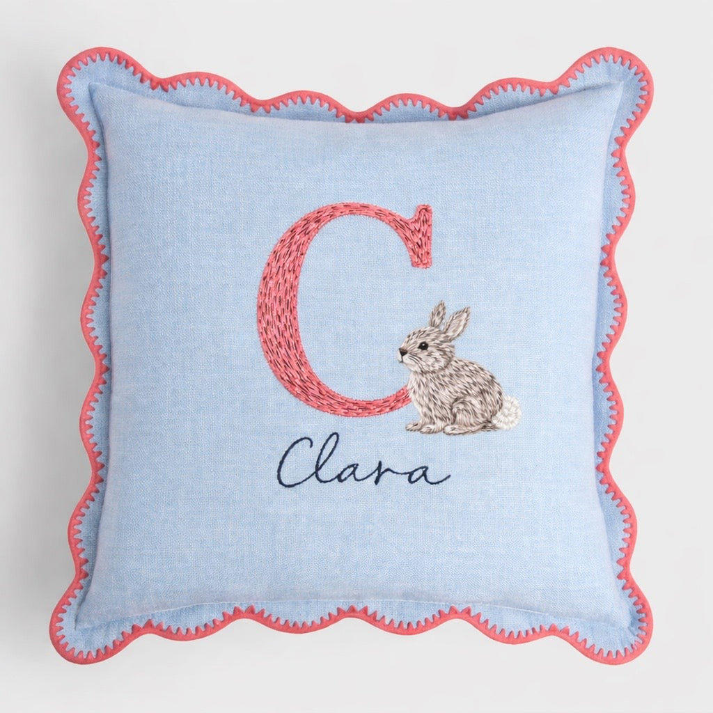 Decorative pillow with letter , rabbit illustration, and name on a light blue background -  personalised baby / toddler gift.