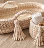 Woven baskets with tassels on a neutral background