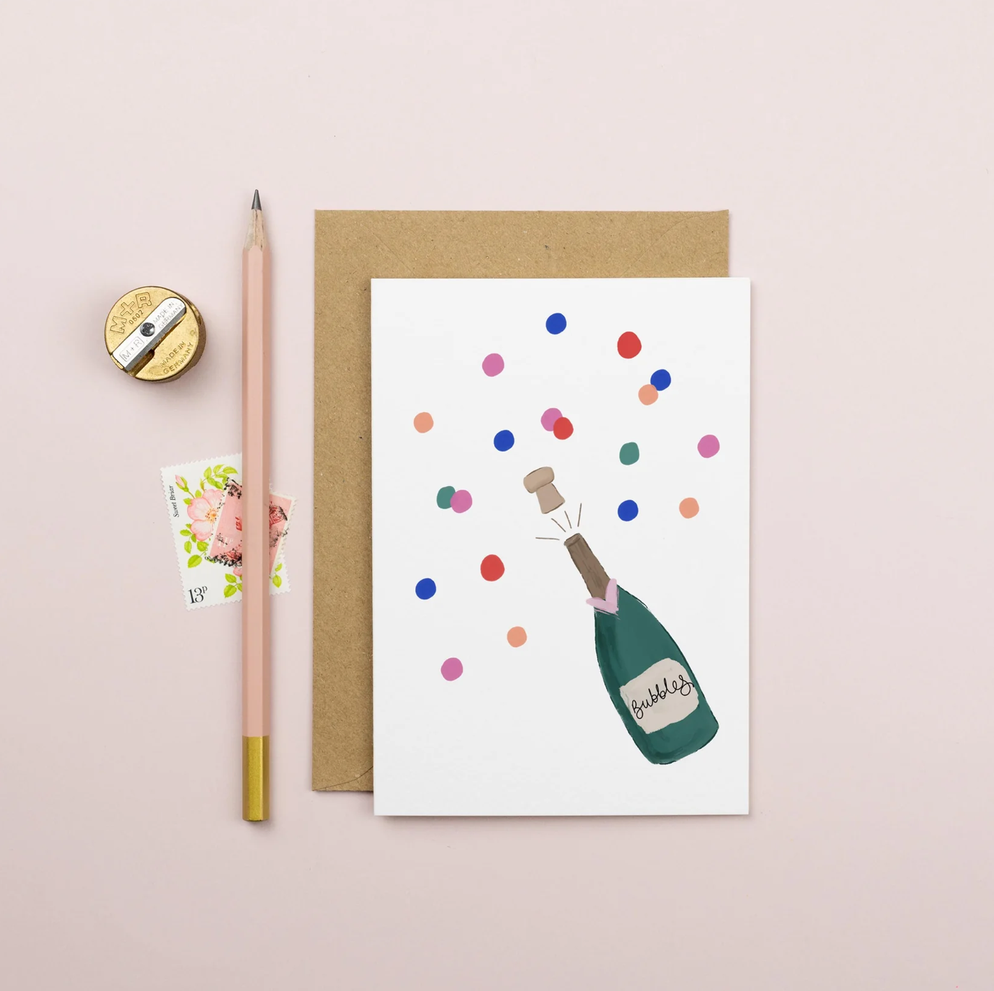 Greeting card with champagne bottle and confetti design on a pink - celebration card.