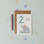 Children's birthday card with an elephant illustration and 'Two Today' text, placed on a light grey background with colourful dots.