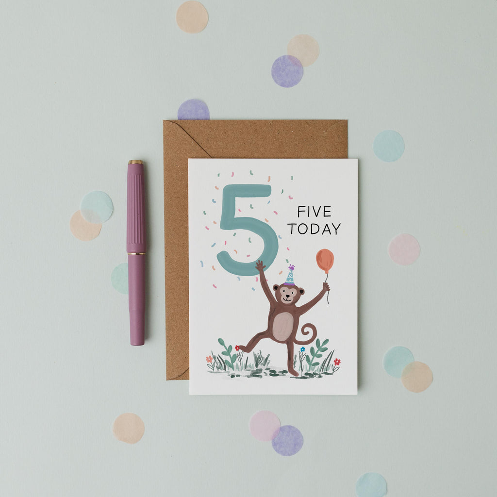Children's birthday card with a monkey illustration and 'Five Today' text, placed on a light blue background with colourful dots.