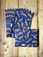 Set of blue wrapping paper sheets with animal pattern on a wooden surface