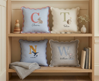 Personalised pillows with names on a wooden shelf - personalised baby / toddler gift.