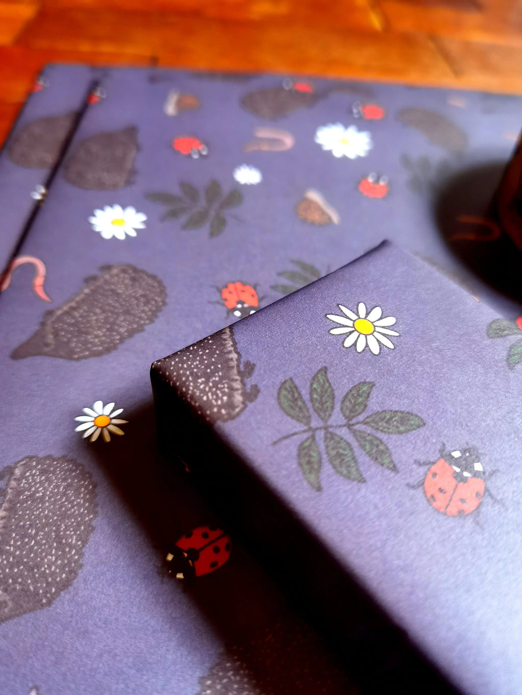 Purple fabric with nature-themed pattern on a wooden surface